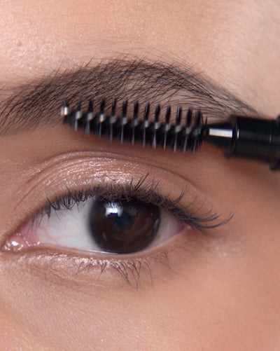 Applying Brow Definer in Dark Brown and Brow Freeze® Gel